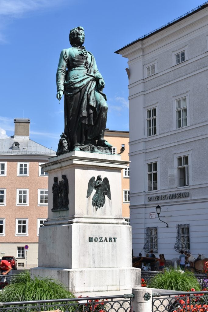 green weathered statue of Mozart in Salzburg