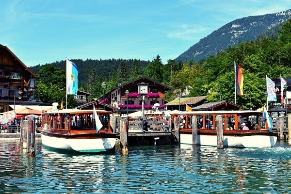 Boat dock with timbered buildings and mountainside