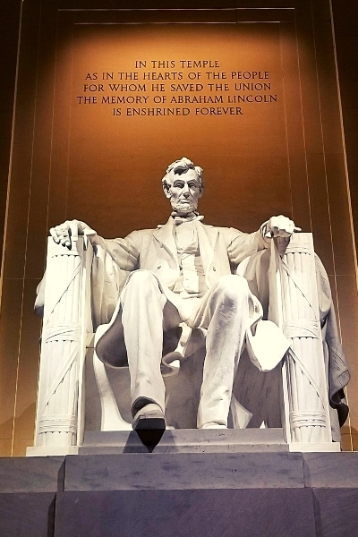 White marble Abraham Lincoln statue at night from the Lincoln Memorial in Washington, DC