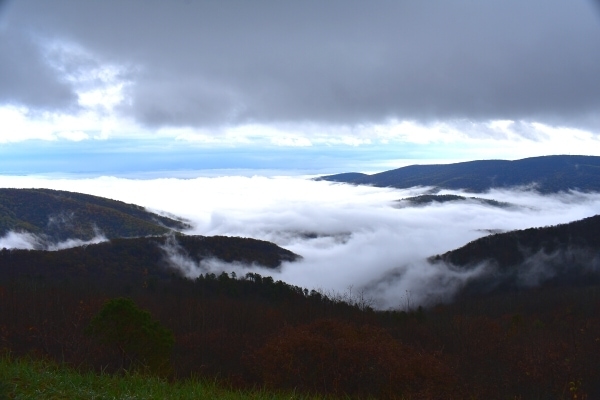 White and Gray clouds fill the mountain valleys of Shenandoah National Park with a sliver of blue sky peeking through.