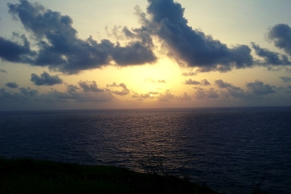 Orange sunrise over the ocean with some clouds on the eastern most point of St Croix, USVI