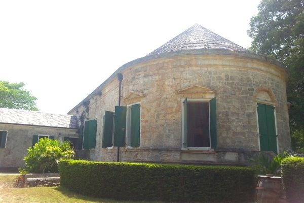St Croix's tan stone Whim Plantation main house with green window shutters