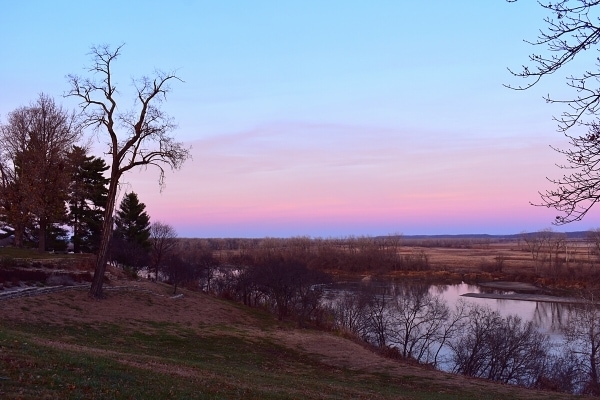 pink sunset sky over a bluff of the Missouri River