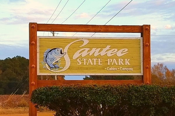 Wooden Santee State Park sign featuring a fish, at the park's main entrance