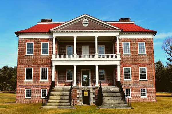 Three story brick plantation home with double covered porches and twin staircases dominates the Drayton Hall plantation
