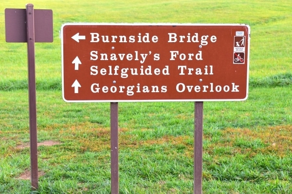 Brown panel sign directing visitors to different locations around Antietam National Battlefield