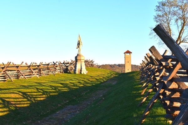 Sunken Road, also known as Bloody Lane, at Antietam Battlefield is lined by wooden fences on both sides and the brown stone observation tower on the end