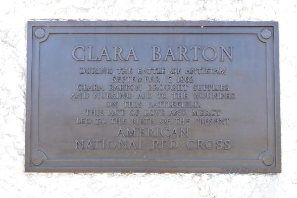 Metal plaque in a white stone memorial commemorating Clara Barton, founder of the American Red Cross