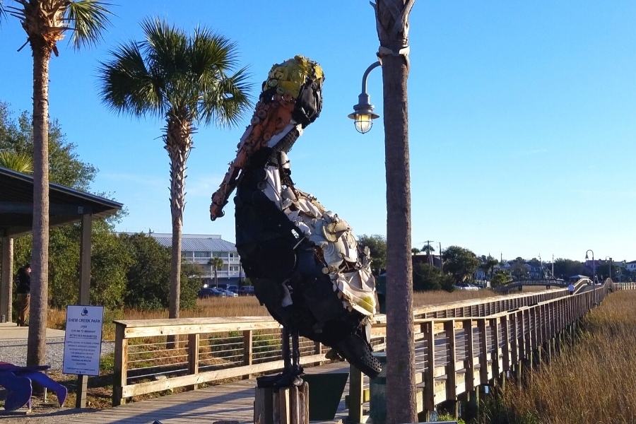 Shem Creek Boardwalk's pelican statue made of plastic found in the ocean