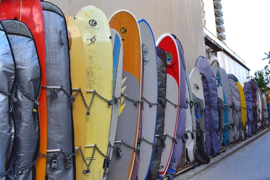 Surfboard storage along a beach public access route near a hotel in Oahu