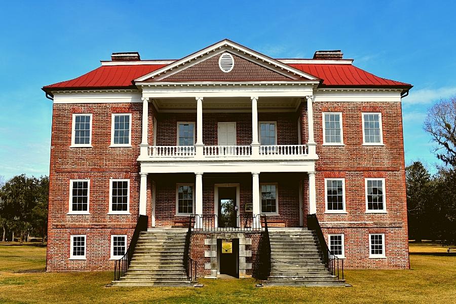 Three story brick Drayton Hall plantation home with double colonnaded front facade and two grand staircases to the entrance