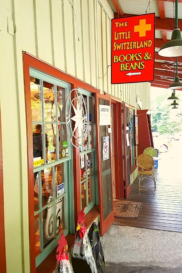 The red and white front of The Little Switzerland Books & Beans store