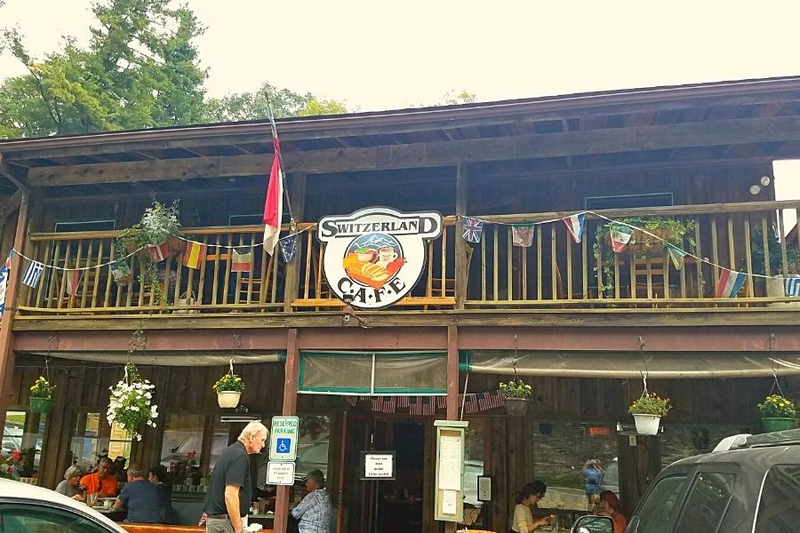 The two-story front facade of the Switzerland Cafe is decked out with banner flags and is always busy