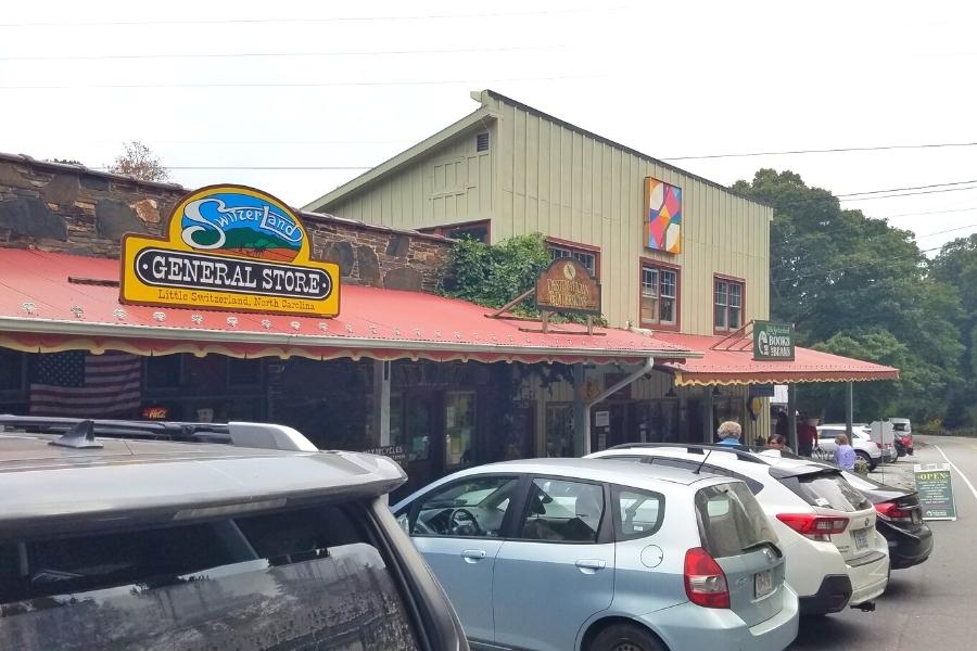 The one and only series of storefronts in Little Switzerland, NC with cars parked out front