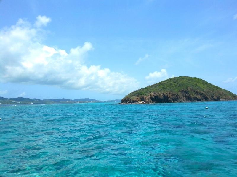 A green cay sits in the aqua blue Caribbean waters off of St Croix