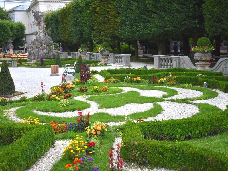 The colorful flowers and green grass in a formal design in Mirabell Palace Gardens in Salzburg