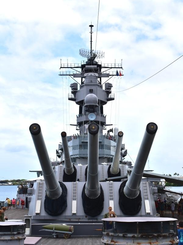 The forward deck guns and front elevation of the USS Missouri battleship in Pearl Harbor, HI