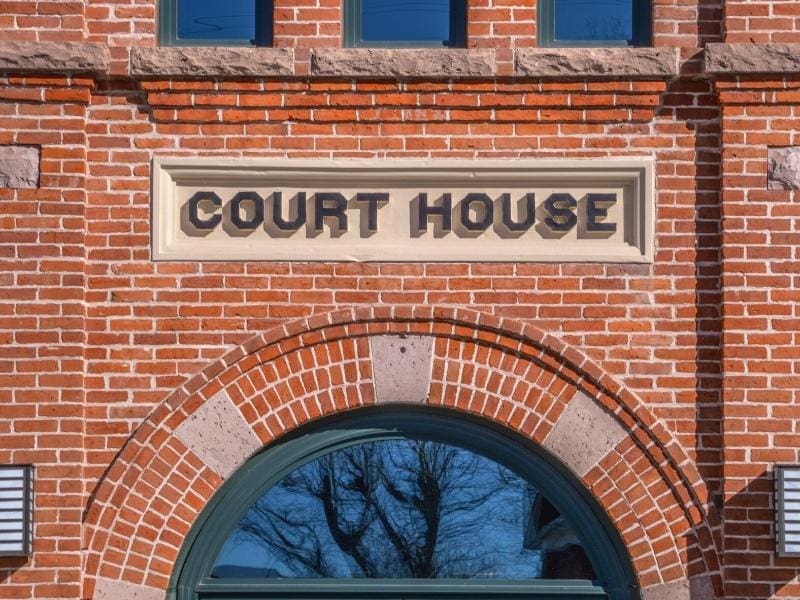 Brick building with "Court House" sign in concrete relief above a window in Panguitch, Utah