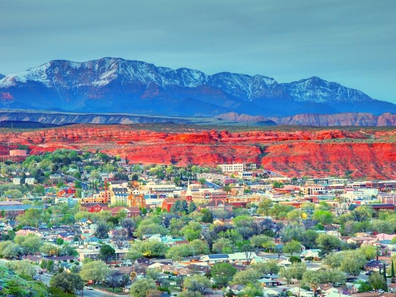 The town of St George is surrounded by red cliffs and snowcapped mountains in southern Utah