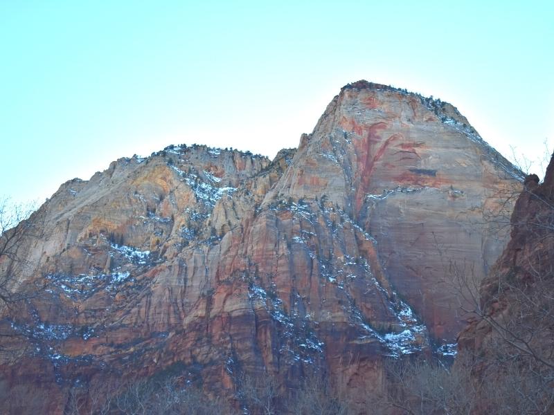 The walls of Zion Canyon glow as the sun sets behind them