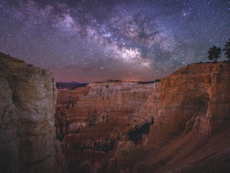 A starry night sky hangs over Bryce Canyon National Park