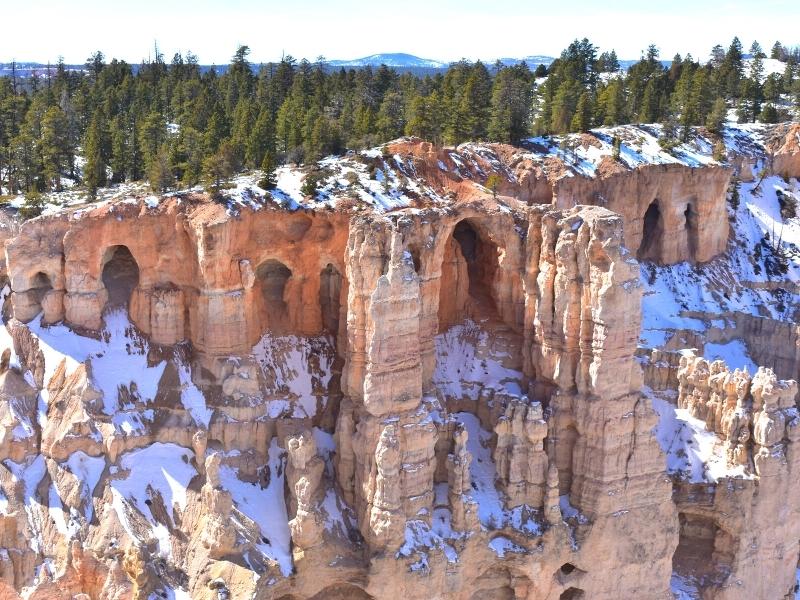 Arches in the canyon wall will one day become hoodoos at Bryce Point