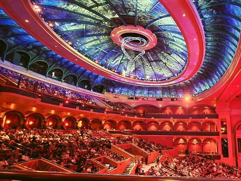 The theater in the Bellagio before a Cirque du Soleil is bathed in red light and filled with people