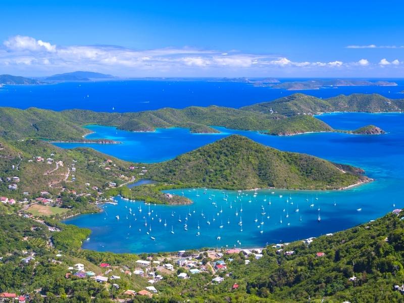 Coral Bay, as seen from the inland overlook point high above, is dotted with white boats on its blue waters