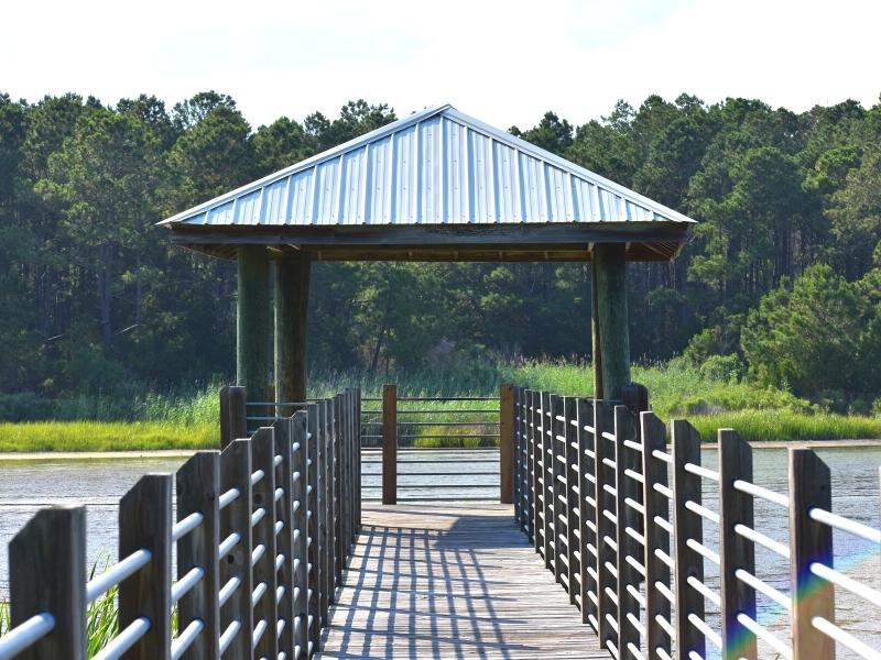 A covered pier in the middle of a pond at Huntington Beach State Park