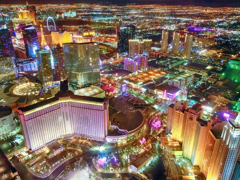 The urban sprawl of Las Vegas and the Strip shines with colorful lights at night