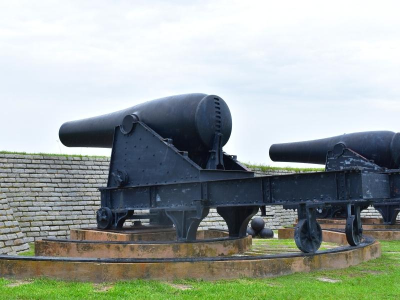 Two large cannons from the Civil War era sit on tracks in their redoubt at Fort Moultrie on Sullivan's Island near Charleston, SC