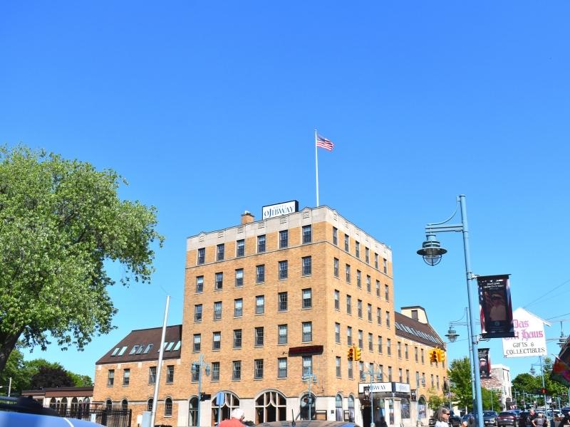 A tan brick building of the Hotel Ojibway anchors downtown Sault Ste Marie