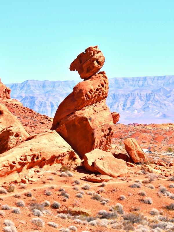 A large rock balances perfectly and precariously, one of the favorite things to do in Valley of Fire State Park at its visitor center