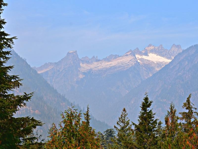 Picket Range in the distance on a hazy day, as seen from the boardwalk viewpoint of the Sterling Munro Trail in North Cascades National Park