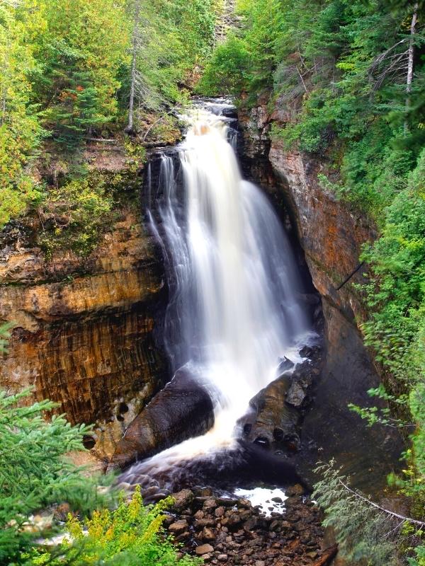 Chapel Falls drops off a rock ledge, forming a gorge in the forest of Pictured Rocks before finishing its journey to Lake Superior