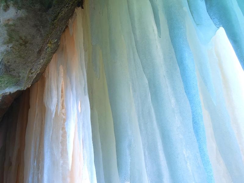 An ice curtain reflects a rainbow of colors at Pictured Rocks National Lakeshore in the winter