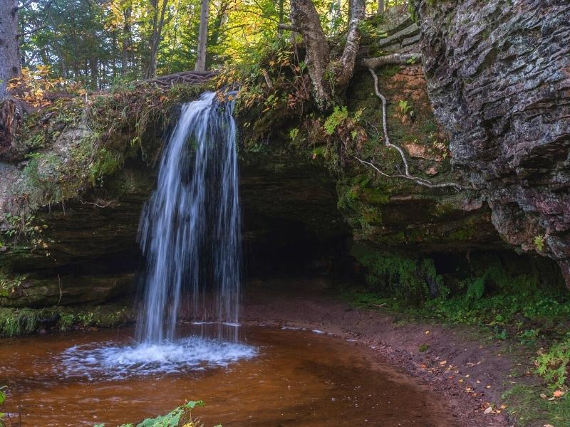 Small Scott Falls drops into a small pool at the base of it's rock ledge in the forest of Michigan's Upper Peninsula