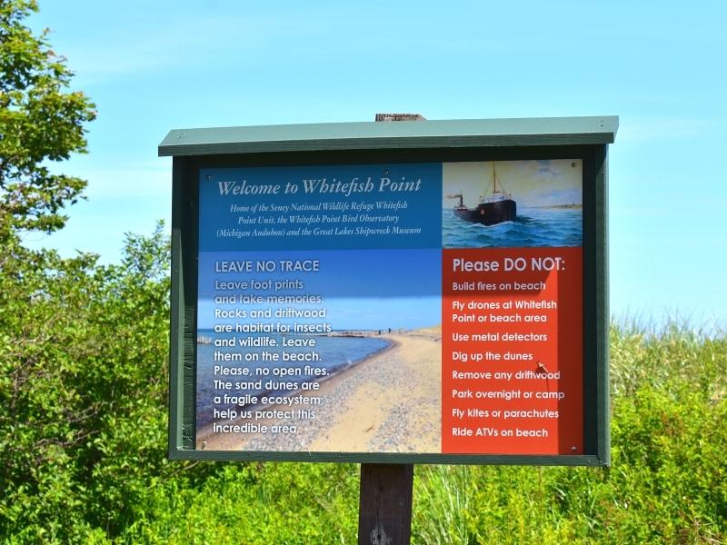 An informational sign at Whitefish Point Beach describing the Leave No Trace principles and prohibited beach activities.