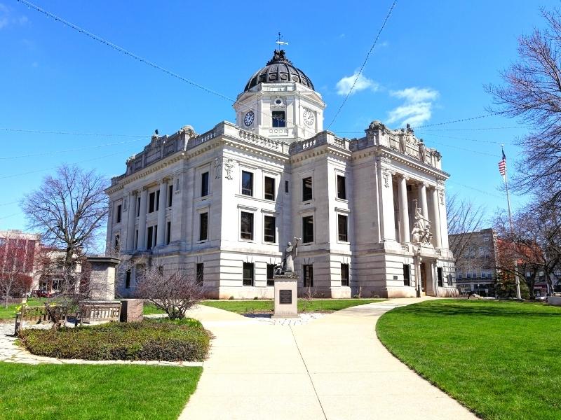 An imposing stone county courthouse dominates a square in Bloomington, IN