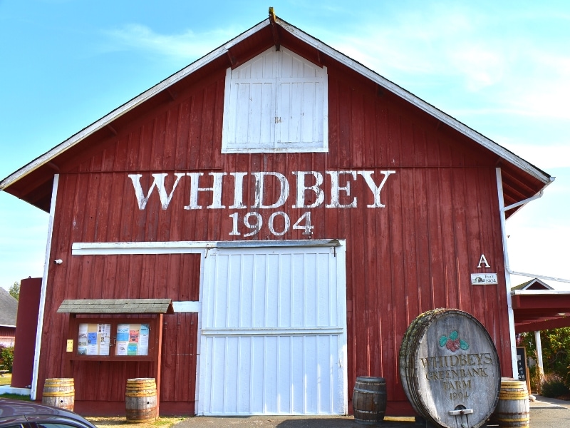 A red barn with sign Whidbey 1904, stands at the Greenbank Farm on Whidbey Island