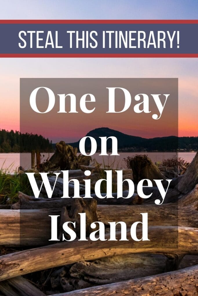The sunset turns the sky pink and orange, illuminating the driftwood on the Whidbey Island beach, with text Steal this Itinerary: One Day on Whidbey Island
