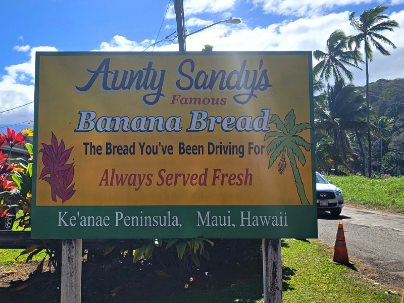 The yellow Aunt Sandy's Famous Banana Bread sign outside her store on the Keane Peninsula on the Road to Hana