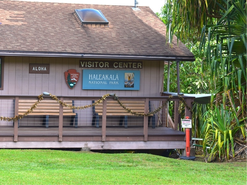 A blue sign marks this otherwise brown building as the Haleakala National Park Kipahulu District Visitor Center