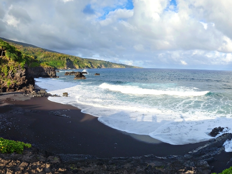 Waves crash on the black sand beach at the base of Oheo Gulch in the Kipahulu District of Haleakala National Park