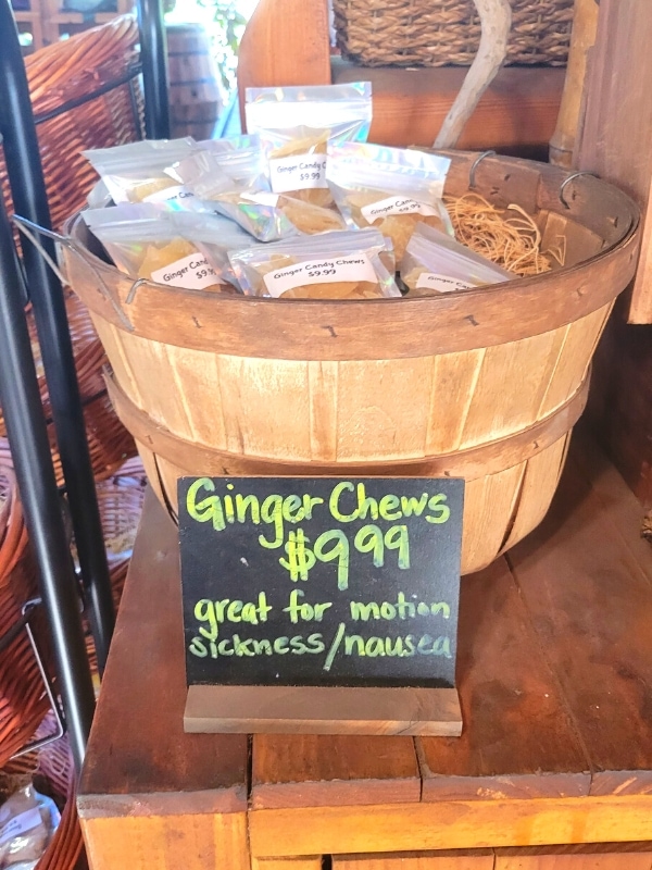 A barrel of ginger chews sits on a shelf at the Hana Farm store, noting the price and that their great for motion sickness