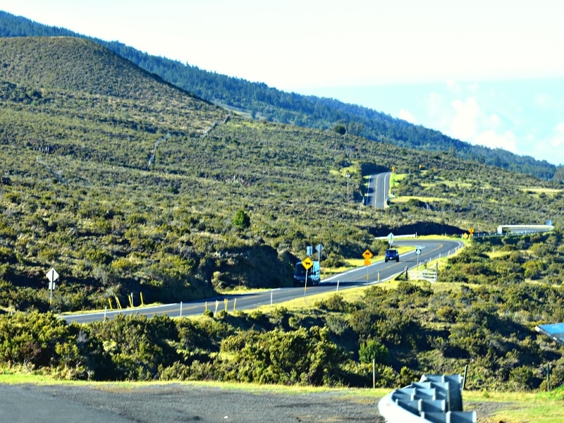A roadway loops and curves up and down the sideslope of Haleakala volcano on Maui