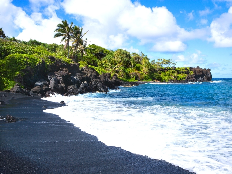 The black sand beach at Waianapanapa State Park on the Road to Hana in Maui