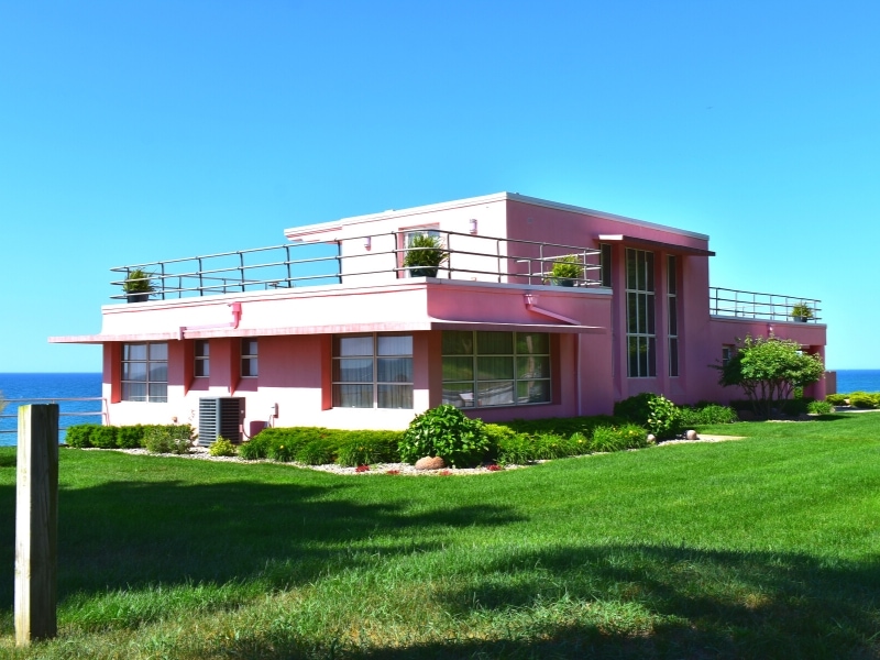 The pink Florida tropical Century of Progress home sits on the bluff above Lake Michigan in Indiana Dunes National Park