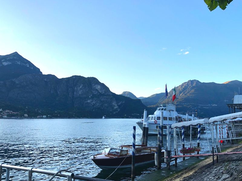 The ferry dock in Bellagio, Lake Como, Italy with views of the lake and mountains in the background