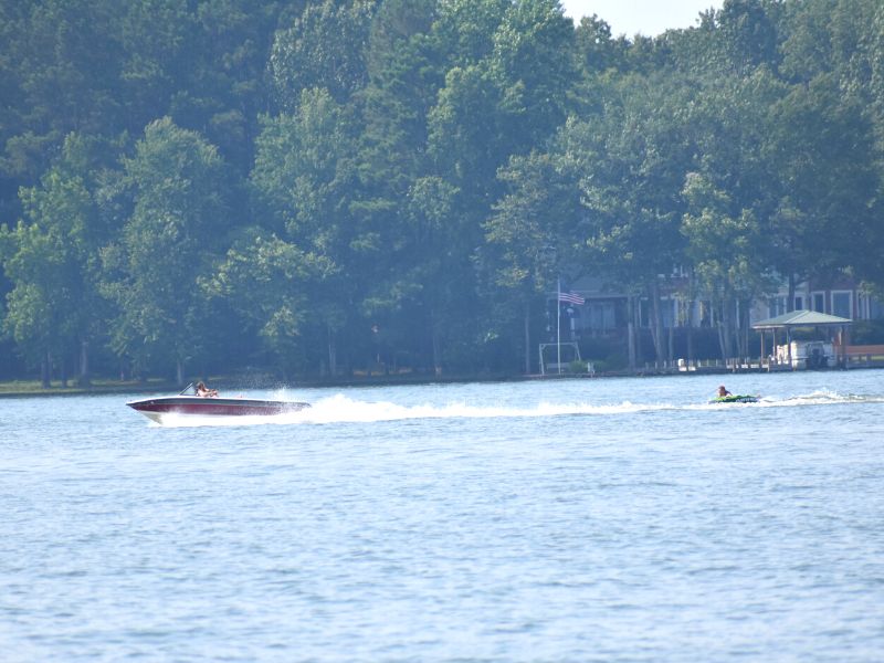 A speed boat pulls a tube behind as it cruises across Lake Greenwood in South Carolina